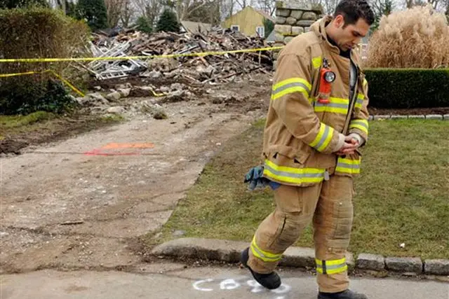 A firefighter after paying respects at the site of the devastating house fire